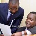 David Oloka (R) consults with his lawyer Nathan Osinde at a recent court session at the Anti-Corruption Court in Kampala. Photo by Bominic Bukenya
